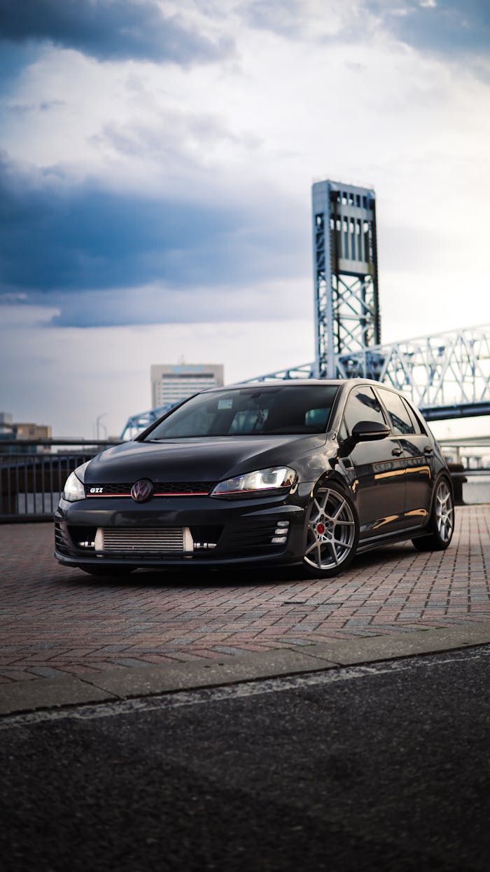 Black Volkswagen Golf VII against Bridge